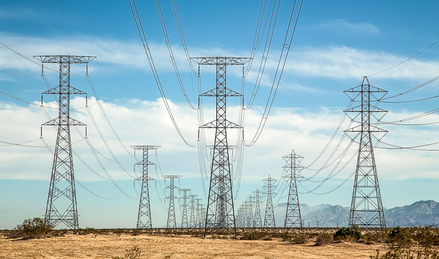 Symmetrical powerline towers in the Yuha Desert of Southern California.